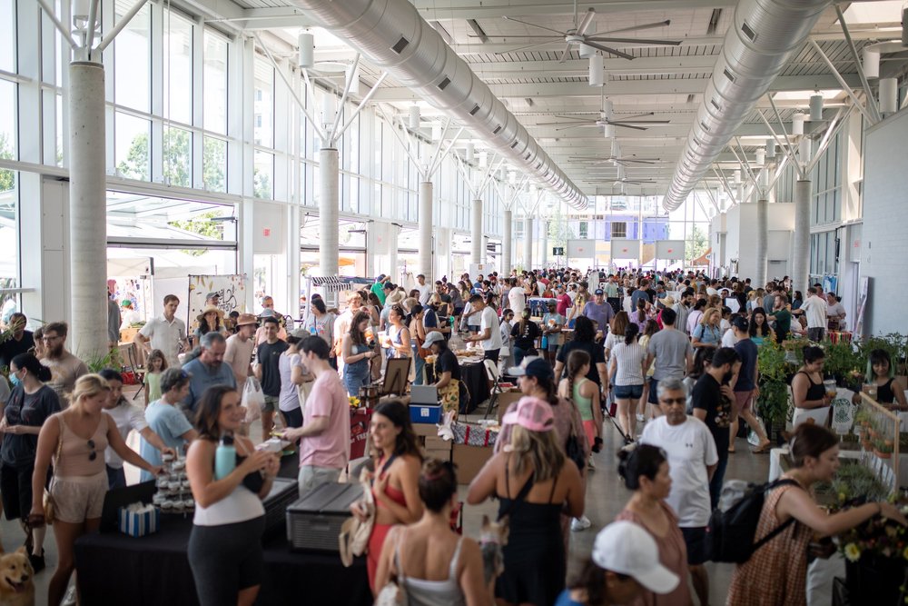 Market stalls and shoppers at the Mueller farmers’ market